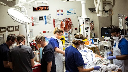 A man brought into the ED under cardiac arrest is worked on by the emergency team in the busy emergency department of the Royal Melbourne Hospital.