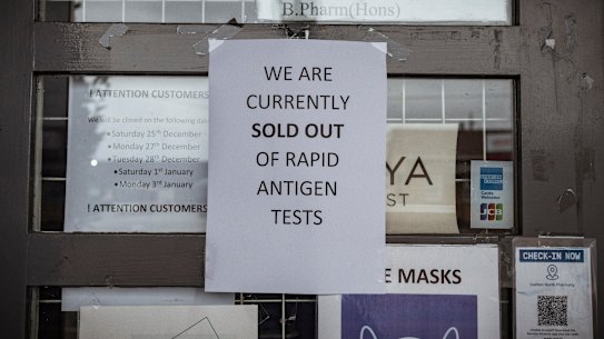 A sign posted to the door of a pharmacy in Carlton informs customers it has sold out of rapid antigen tests.