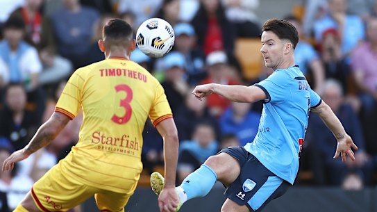 Alexander Baumjohann guides the ball over the Adelaide defence at Leichhardt Oval.
