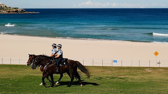 Mounted police patrolling an empty Bondi Beach.