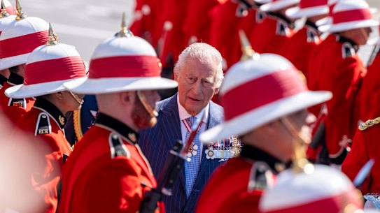 King Charles inspects an honour guard as he arrives at the Senate building in Ottawa.