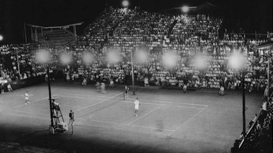 A capacity crowd at Milton, Brisbane watches Lew Hoad and Pancho Gonzales in their first professional match. Gonzales won 5-7, 8-6, 6-2, 4-6, 9-7.