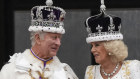 The King and Queen talk on the balcony at Buckingham Palace.