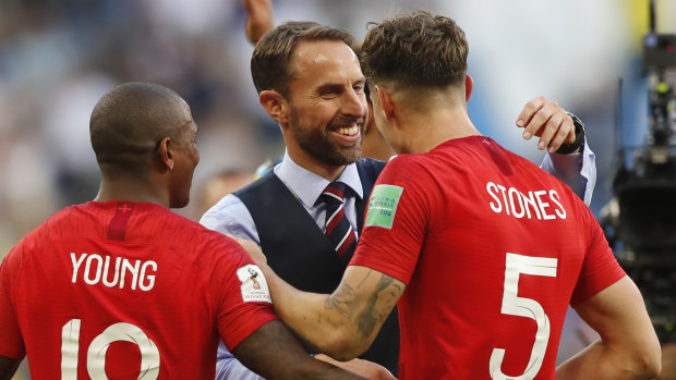 Job done: England coach Gareth Southgate congratulates John Stornes after the 2-0 quarter-final win over Sweden.