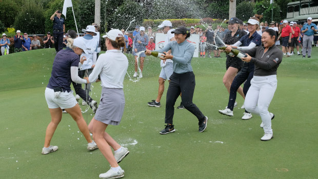 Stephanie Kyriacou celebrates with champagne after her breakthrough victory.