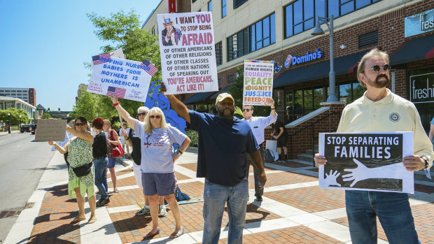 People line up to protest Jeff Sessions and immigration reform in Fort Wayne, Indiana on Thursday.
