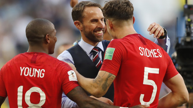 Job done: England coach Gareth Southgate congratulates John Stones after the 2-0 quarter-final win over Sweden.