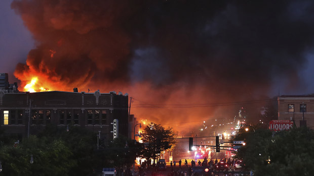 A fire burns in Minneapolis on the third night of unrest following the death of George Floyd.