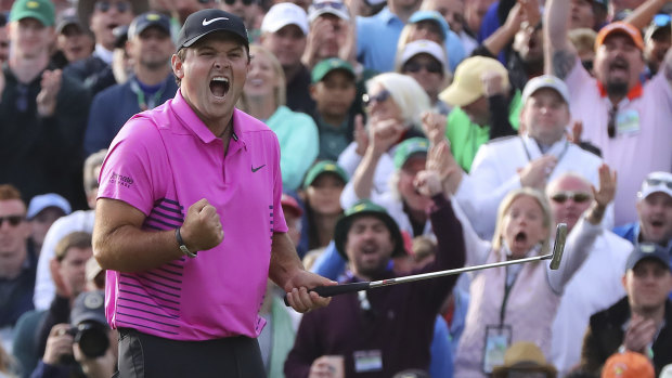 In the pink: Patrick Reed celebrates after draining the winning putt.