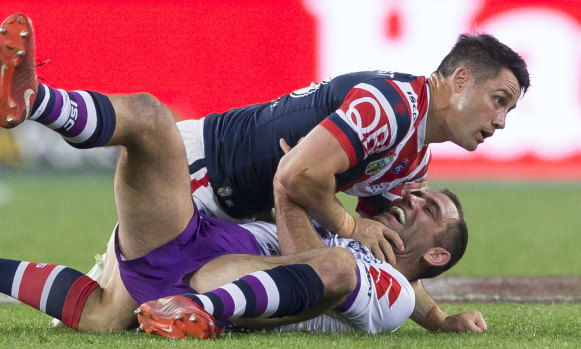 Strained relationship: Former teammates Cooper Cronk and Cameron Smith collide in the 2018 grand final.