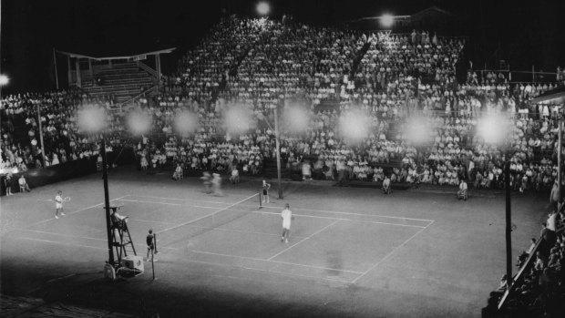 A capacity crowd at Milton, Brisbane watches Lew Hoad and Pancho Gonzales in their first professional match. Gonzales won 5-7, 8-6, 6-2, 4-6, 9-7.