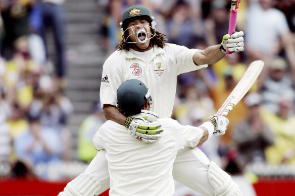 Andrew Symonds celebrates a century at the MCG with Matthew Hayden in 2006.