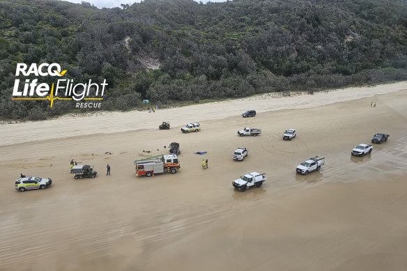 Emergency services at the site of a fatal rollover on Teewah Beach, Cooloola.
