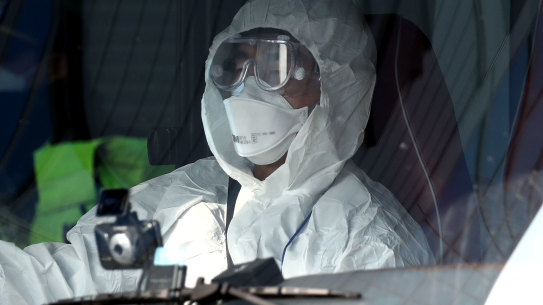 Scary: A rescue worker in an ambulance carrying a South Korean citizen who was  repatriated from Wuhan, China with flu-like symptoms.