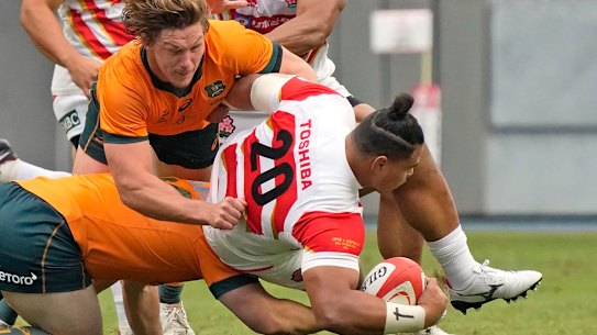 Australia’s Michael Hooper tackles Japan’s Tevita Tatafu during a rugby international match between the Wallabies and Japan in Oita, Japan, Saturday, Oct. 23, 2021. (Kyodo News via AP)