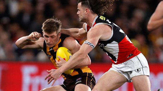 Dylan Moore is tackled by Jack Sinclair. 