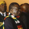 Zimbabwean President Emmerson Mnangagwa, left, is greeted as he arrives at Robert Mugabe International Airport in Harare on Monday.