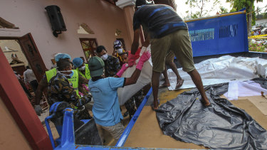 The bodies of victims are removed from St Sebastian's Church  in Negombo on Sunday.