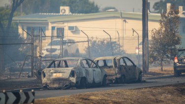 Burnt-out cars sit near a childcare centre in Seaford that was evacuated during a series of fires in the area on Friday.