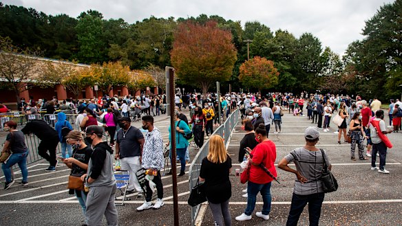 Hundreds of people wait in line for early voting in Marietta, Georgia.