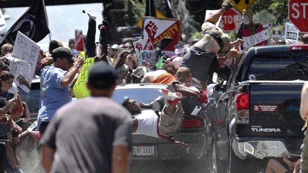 People fly into the air as a vehicle is driven into a group of protesters demonstrating against a white nationalist rally in Charlottesville, Virginia in 2017. 