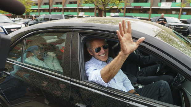 Democratic presidential candidate and former vice president Joe Biden waves goodbye after stopping at a pizza shop in Wilmington, Delaware.