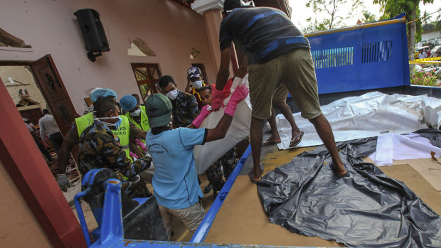 The bodies of victims are removed from St Sebastian's Church  in Negombo on Sunday.