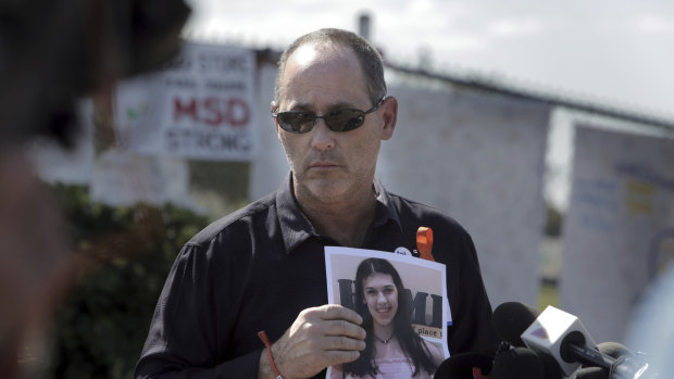 Fred Guttenberg holds a picture of his daughter Jamie, killed in a high school shooting. 