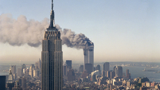 The twin towers of the World Trade Centre burn behind the Empire State Building in New York on September 11, 2001.