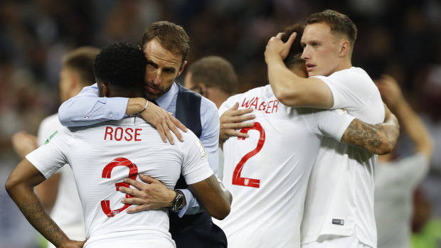 England head coach Gareth Southgate comforts players after England's loss.
