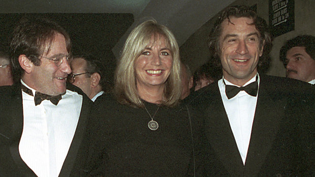 Penny Marshall poses with co-stars of "Awakenings" Robin Williams, left, and Robert De Niro at the 1990 premiere of the film in New York.