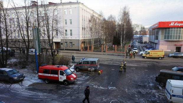 Emergency services cars surround the FSB office where a young man blew himself up. 