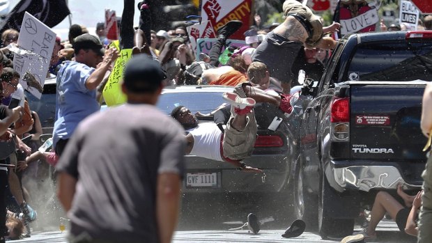 People fly into the air as James Alex Fields jnr's vehicle is driven into a group of protesters in Charlottesville. 