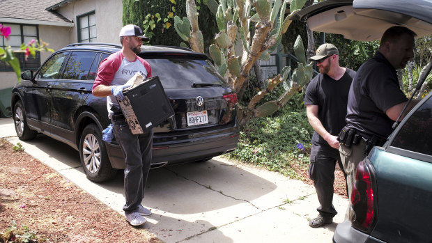 FBI agents remove evidence from the home of Robert Chain in the Encino, Los Angeles, on Thursday.
