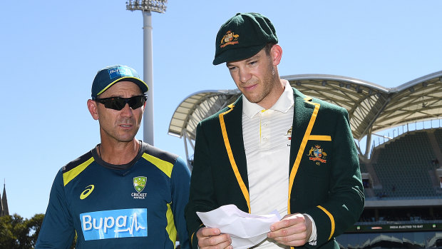 Long day ahead: Australian coach Justin Langer walks from the field with Tim Paine after losing the toss.
