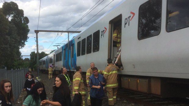 Firefighters assist passengers left stranded on carriages that separated from a moving train at Croydon.  