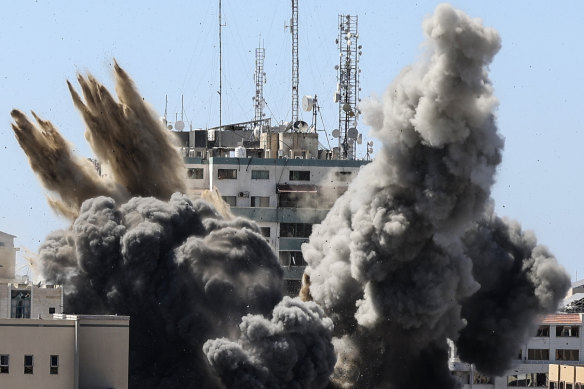 Smoke billows from a building housing various international media after an Israeli airstrike.
