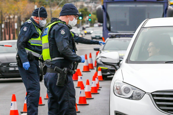 Police speak to drivers at a roadblock in the COVID-19 hotspot of Ascot Vale on Saturday.