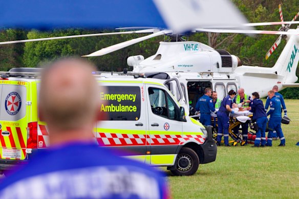 Paramedics prepare to transport the injured by helicopter.