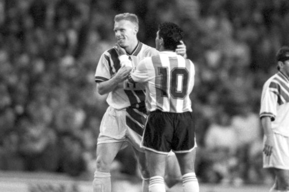 Robbie Slater - aka El Colorado - embraces Diego Maradona after the 1-1 draw in Sydney.