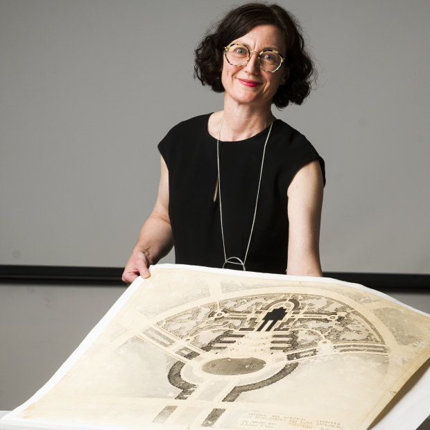 Senior curator of offical and private records Margaret Farmer with some of the original designs from the Australian War Memorial before they were scrapped