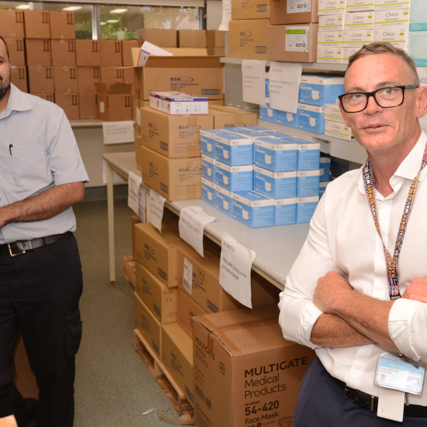 Rob Moloney (right) and PA Hospital nurse Gaurang Thakkar with some of the PPE stockpile.