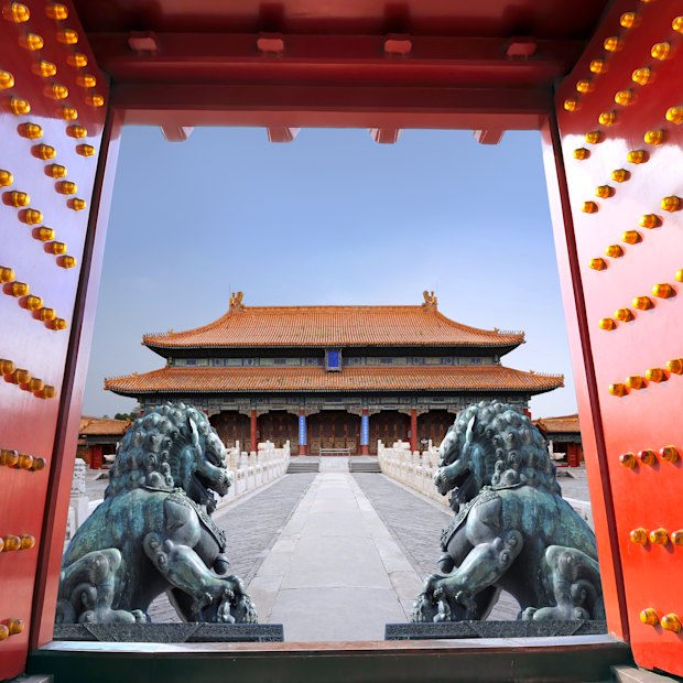 Red entrance gate opening to the Forbidden City in Beijing.