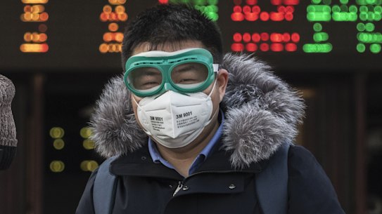 Chinese travellers wear protective masks and goggles after getting off a train in Beijing.