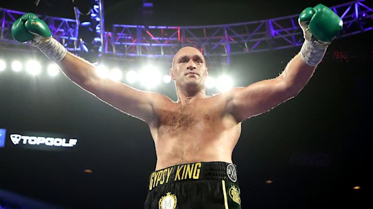 Tyson Fury celebrates after knocking down Deontay Wilder during their heavyweight championship bout in Las Vegas.
