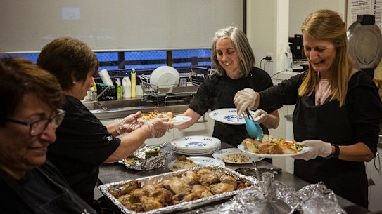 Volunteers Marie, Irene, Pilomina and Beverly prepare meals for the homeless and needy at the Hope Cafe in Fawkner.