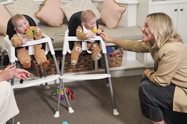 Identical twins Arthur (Artie) and Jack Porter hear for the first time after cochlear implants are switched on as their mum Emily looks on.