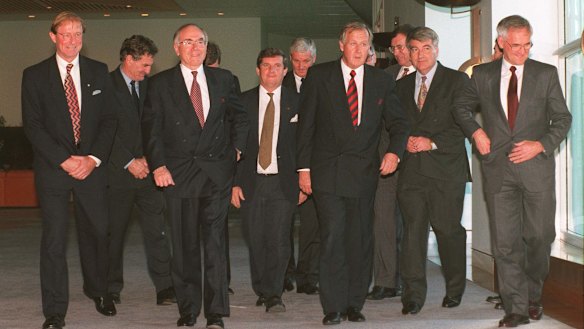 John Howard leads the State Police Ministers to the conference room to discuss gun law reform.