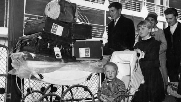 A British family wheel their luggage off a ship after arriving in Port Melbourne in February 1964. 