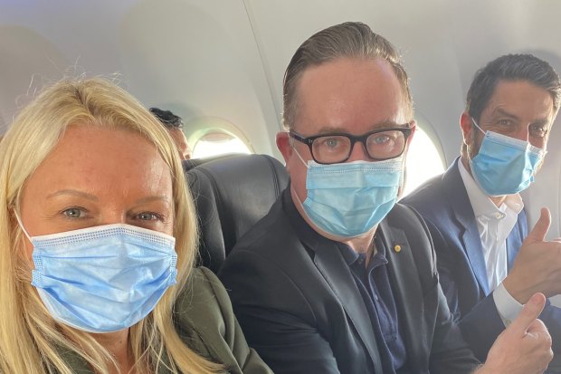 Happy with the middle seat in an early flight back in June: Qantas chief executive Alan Joyce, centre, with chief customer officer Steph Tully and Qantas International chief executive Tino La Spina.